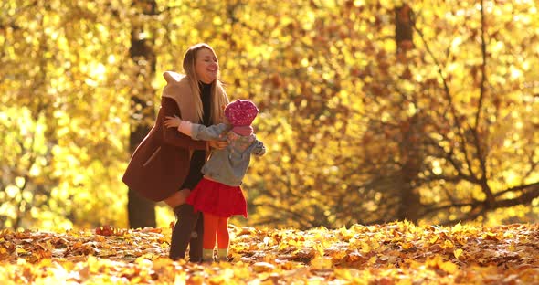 Mother Twisting Her Daughter in the Park.