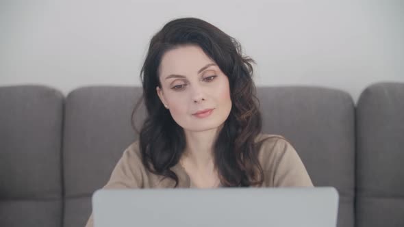 Freelancer woman doing distant work from home with laptop computer alt