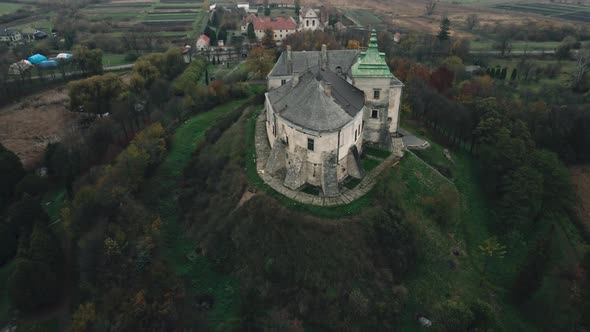 Aerial View of Old Fairytale Castle on the Hill in Ukraine alt