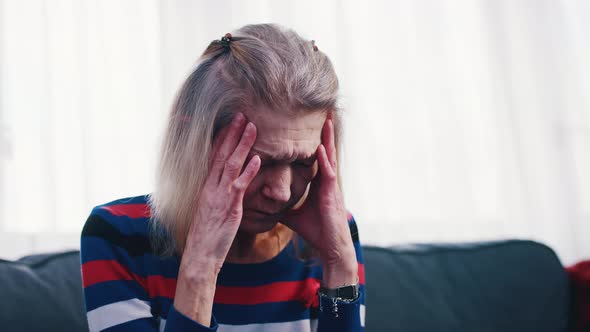 Elderly Woman Having a Headache alt