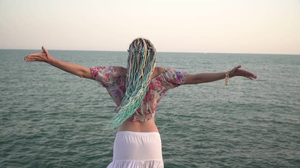 An Attractive Woman Enjoys Freedom Against the Backdrop of the Sea alt