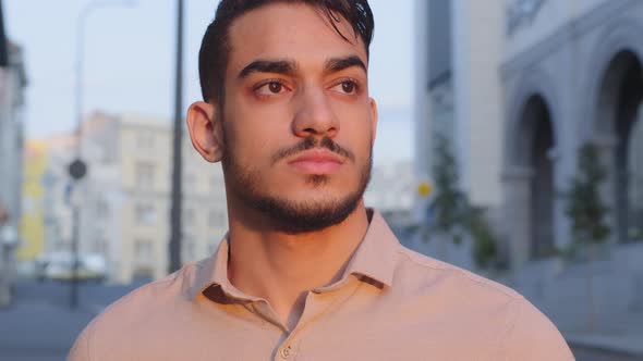 Close Up View of Good Looking Hispanic Business Man in Shirt Looking Away Dreaming Standing in City alt