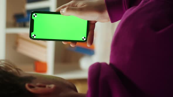 Vertical Video of Man Using Smartphone with Chroma Key Closeup alt