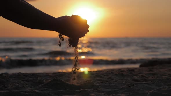 Sand As the Time Slips Through Your Fingers. Little Girl Holding a Sand Sea Background. Sand in Your alt