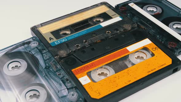 Four Audio Cassettes Rotate on White Background