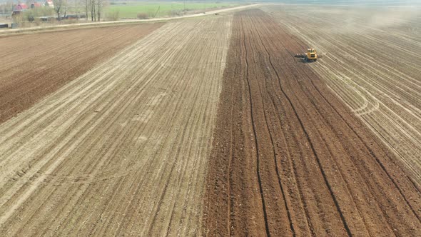 Tractor with Disc Harrows on the Farmland alt