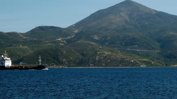 Cargo Ship Pass Harbor of Milos Island Greece