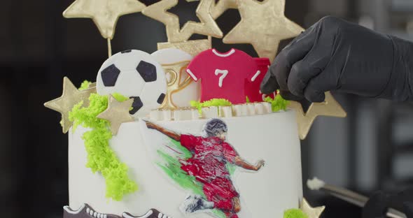 Professional Confectioner Decorates the Holiday Cake with Various Sweet Elements alt