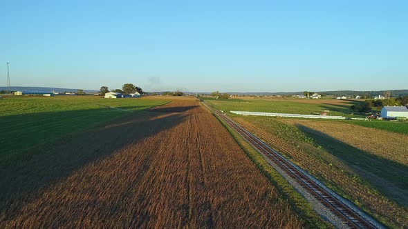 Drone View of Crops Waiting to be Harvested as a Stream Passenger Train Approaches During the Golden alt