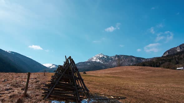 Rural mountain landscape after winter, blue sky with fast moving clouds, alt
