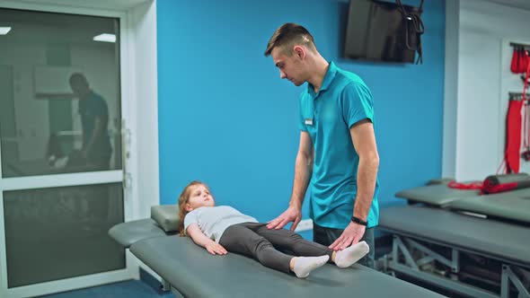 Young Girl Doing Exercises Under Physiotherapist Supervision alt