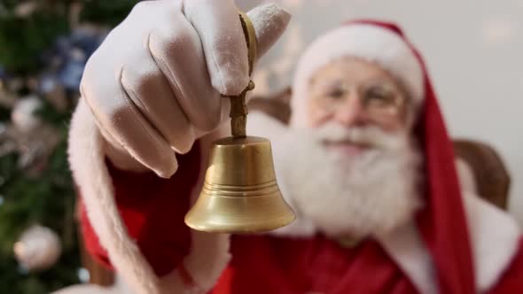 Santa Claus ringing a small bell. Jingle Bells. Savings on purchases.