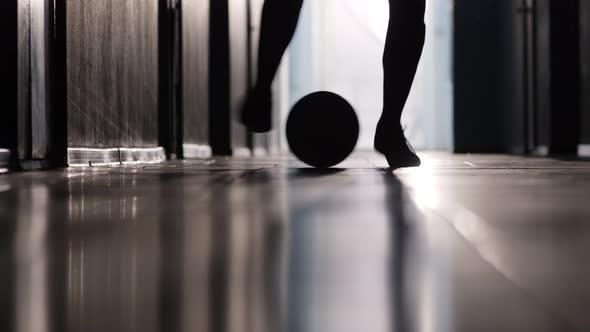 Feet of Soccer Player Dribbling a Ball