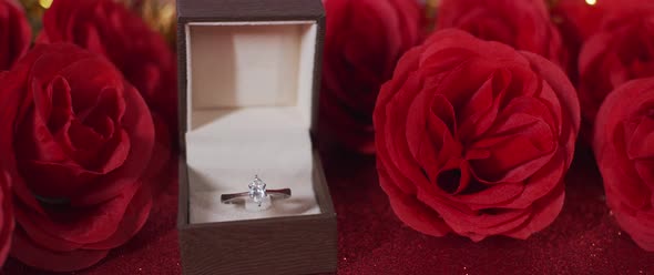 Diamond ring in a box and silk Red roses