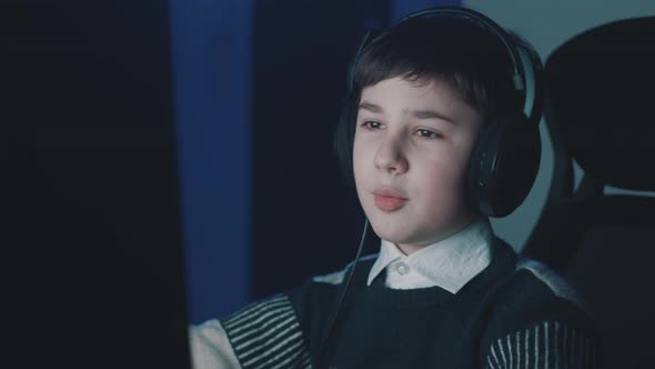 Little Boy Chatting Online By Video Calling with Laptop Computer Late at Night in Living Room of alt