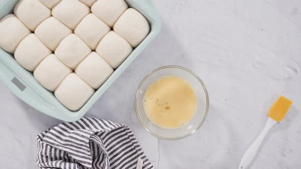 Flat lay. Preparing dinner rolls from the frozen dough in baking pan. alt
