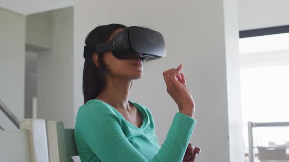 African american woman using vr headset while working from home alt