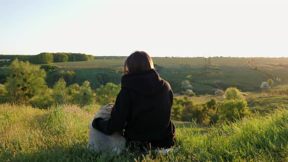 Woman Hugs Her Dog on Sunset alt