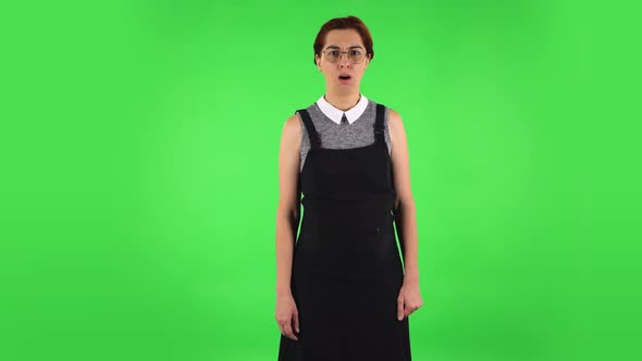 Funny Girl in Round Glasses Is Scolding and Shaking Her Index Finger. Green Screen alt
