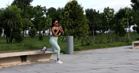 Black Athletic woman goes in for fitness outdoor.