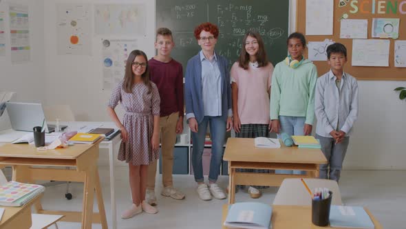 Teacher and Middle Schoolers Posing in Classroom alt