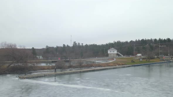 aerial drone following a young woman on a winter day alt