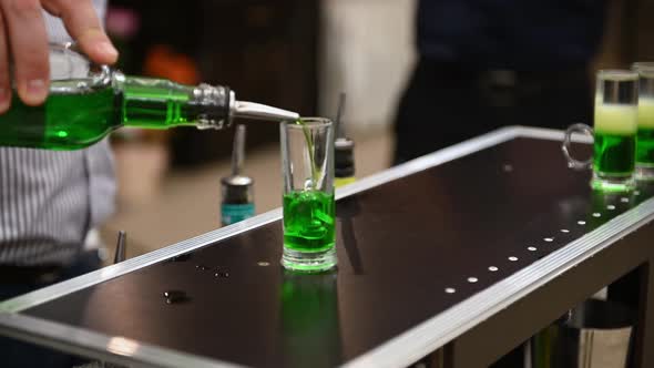 The Barman Is Preparing a Green Mexican Cocktail on the Bar in a Bar or Restaurant. Night Life