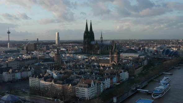 Aerial Footage of Block of Historic Buildings on Waterfront at Golden Hour alt