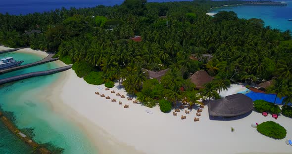 Luxury aerial tourism shot of a white paradise beach and turquoise sea background in hi res 4K alt