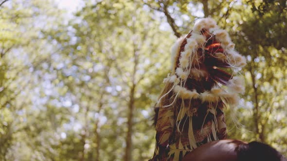 Woman In Headdress Riding Horse Through Sunlit Forest alt