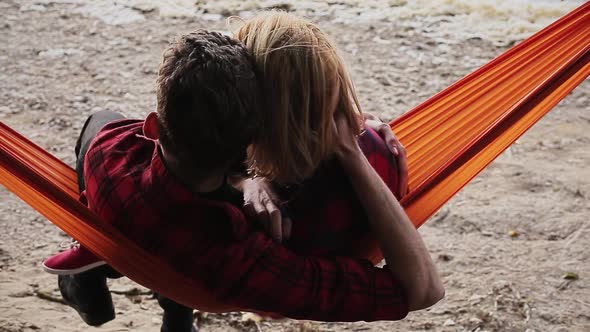 Happy Girlfriend Relaxing with Boyfriend in Hammock alt