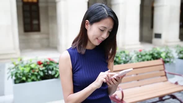 Woman using mobile phone alt
