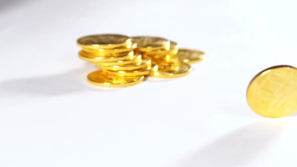 Slow Motion Model Created As Currency Rotates Against Coins Heap alt