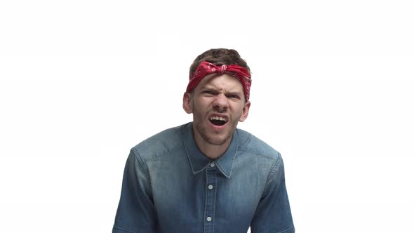 Video of Handsome Young Man in Red Bandana Frowning and Looking Closer with Confused Face Then Put
