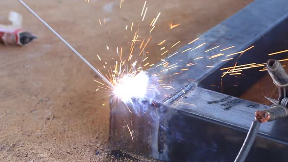 hand of worker welding metal
