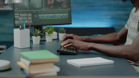 Close Up of Black Videographer Working with Video Editing Software alt
