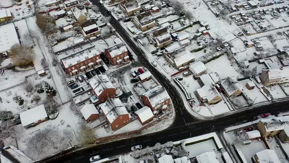 Aerial footage in the winter time on a snowy day of the British town of Mirfield in Kirklees alt