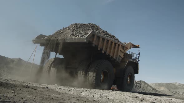 Mining Dump Truck Leaves the Place of Loading with a Full Body of Coal