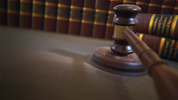 Gavel hitting sound block in court of law. Symbol of justice, judge, authority alt