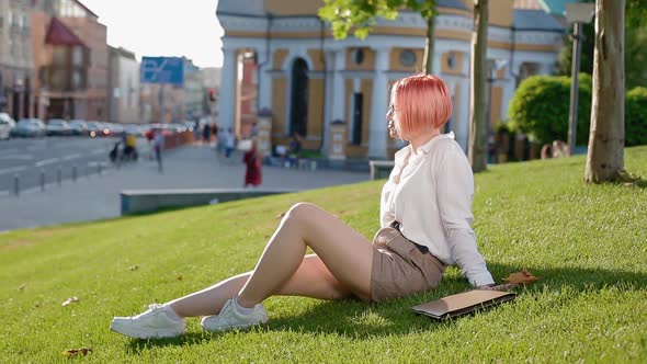 Student Girl Enjoying Sun in the Park alt