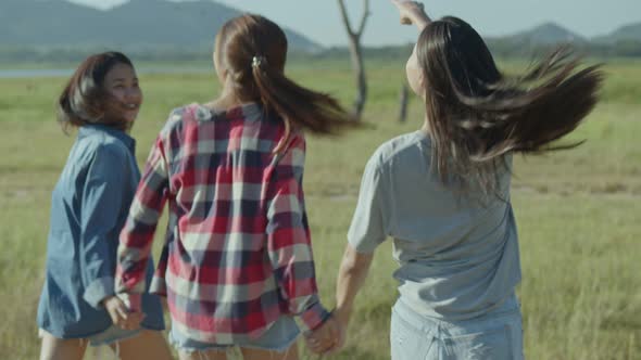 Group of young Asian women running having fun together a summer traveling.