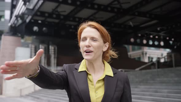 Businesswoman shaking hands with Businessman outdoors in the city