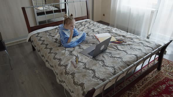 Preschool Girl in Kegurum with Laptop Studying in Room