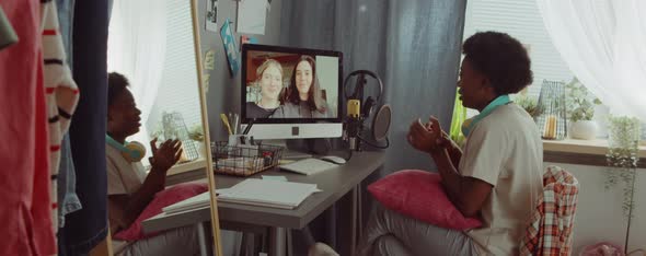 African American Woman Speaking with Friends on Web Call at Home alt