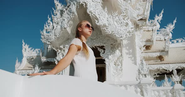 Side View of Woman Walking in White Temple Wat Rong Khun in Chiang Rai Thailand