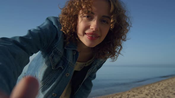 Happy Woman Smiling Turning on Camera on Beach Close Up alt