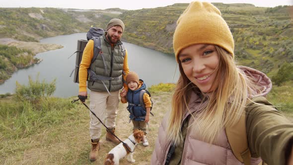 Happy Family Taking Selfie on Hike alt
