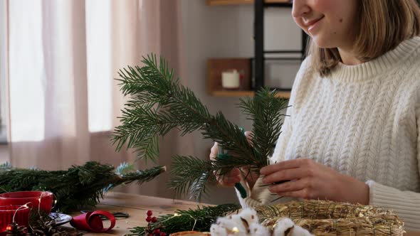 Happy Woman Making Fir Christmas Wreath at Home