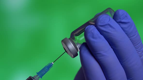 Health Doctor Dials Vaccine Into Syringe with Needle