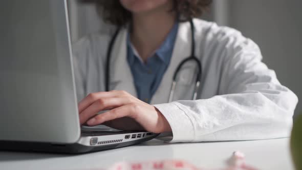Medical Doctor Is Typing Typing On A Laptop Computer. Doctor's Hands Are Working Typing alt